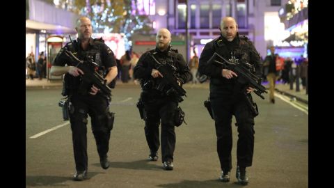 Armed police patrol near Oxford Street as they respond to an incident on Friday in London.