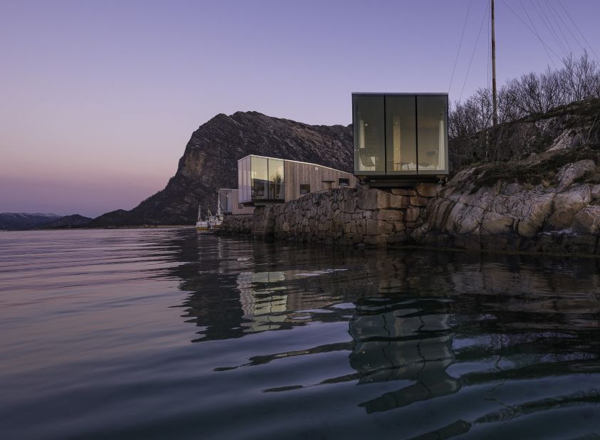 Architect Snorre Stinessen has created a series of idyllic Nordic holiday homes made from glass and timber that perch on the ledge of Manshausen Island. 