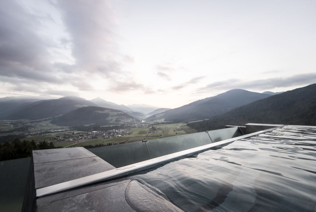 At the Hotel Hubertus in Italy, the pool cantilevers off the building and features as a connector between the old and the new features of the hotel. 