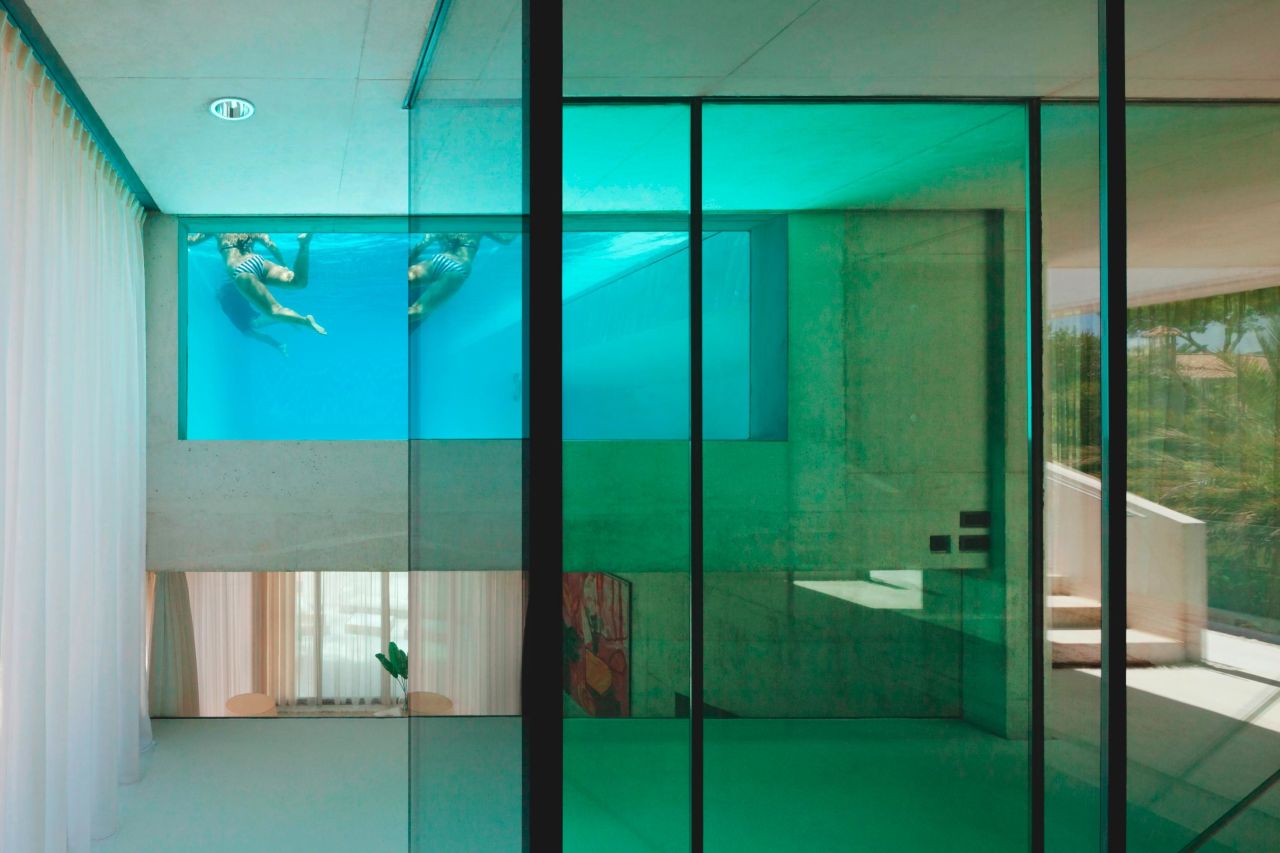 Inside Jellyfish house a glass window within the pool allows people in the kitchen to observe those swimming. 