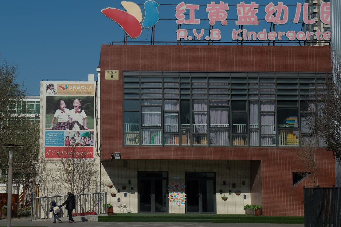 People leave the RYB Education New World kindergarten in Beijing on November 24.