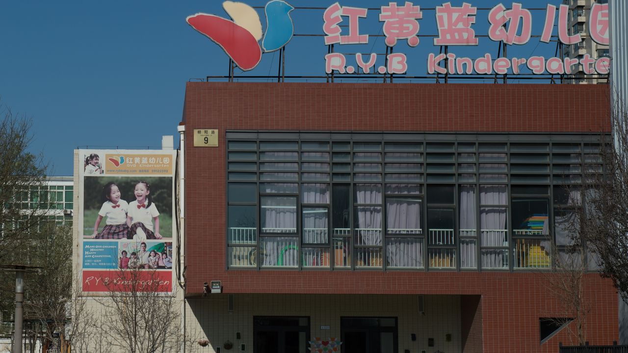 People leave the RYB Education New World kindergarten in Beijing on November 24, 2017.
