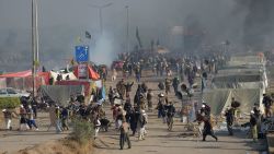 Smoke rises from a blocked flyover as protesters from the Tehreek-i-Labaik Yah Rasool Allah Pakistan (TLYRAP) religious group clash with police in Islamabad on November 25, 2017.