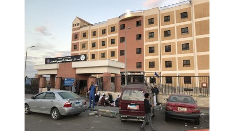 Family members sit outside the Suez Canal University Hospital on Sunday, awaiting word on injured loved ones.