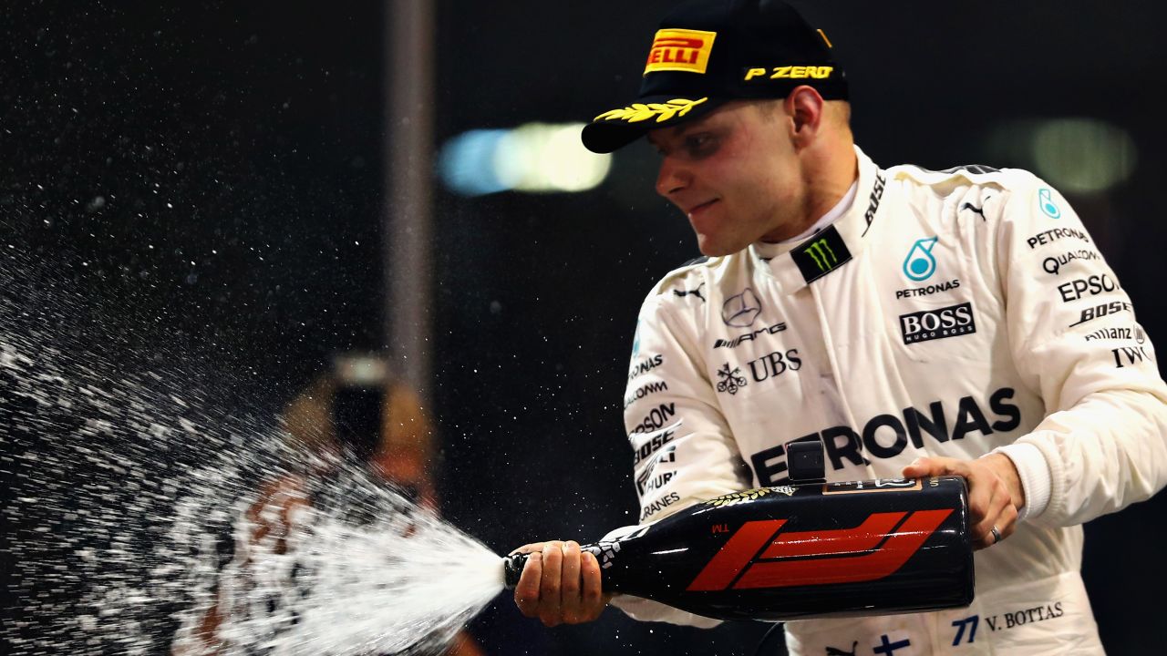 Race winner Valtteri Bottas of Finland and Mercedes GP celebrates on the podium of the Abu Dhabi Grand Prix at Yas Marina. 