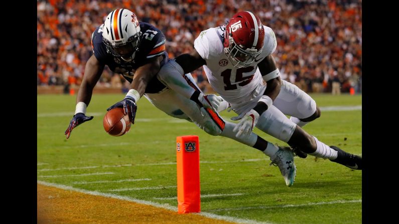 Auburn running back Kerryon Johnson, left, is hit by Alabama's Ronnie Harrison while diving for the goal line on Saturday, November 25. Auburn knocked off its top-ranked rival 26-14 to win the SEC West Division and clinch a spot in the conference title game.