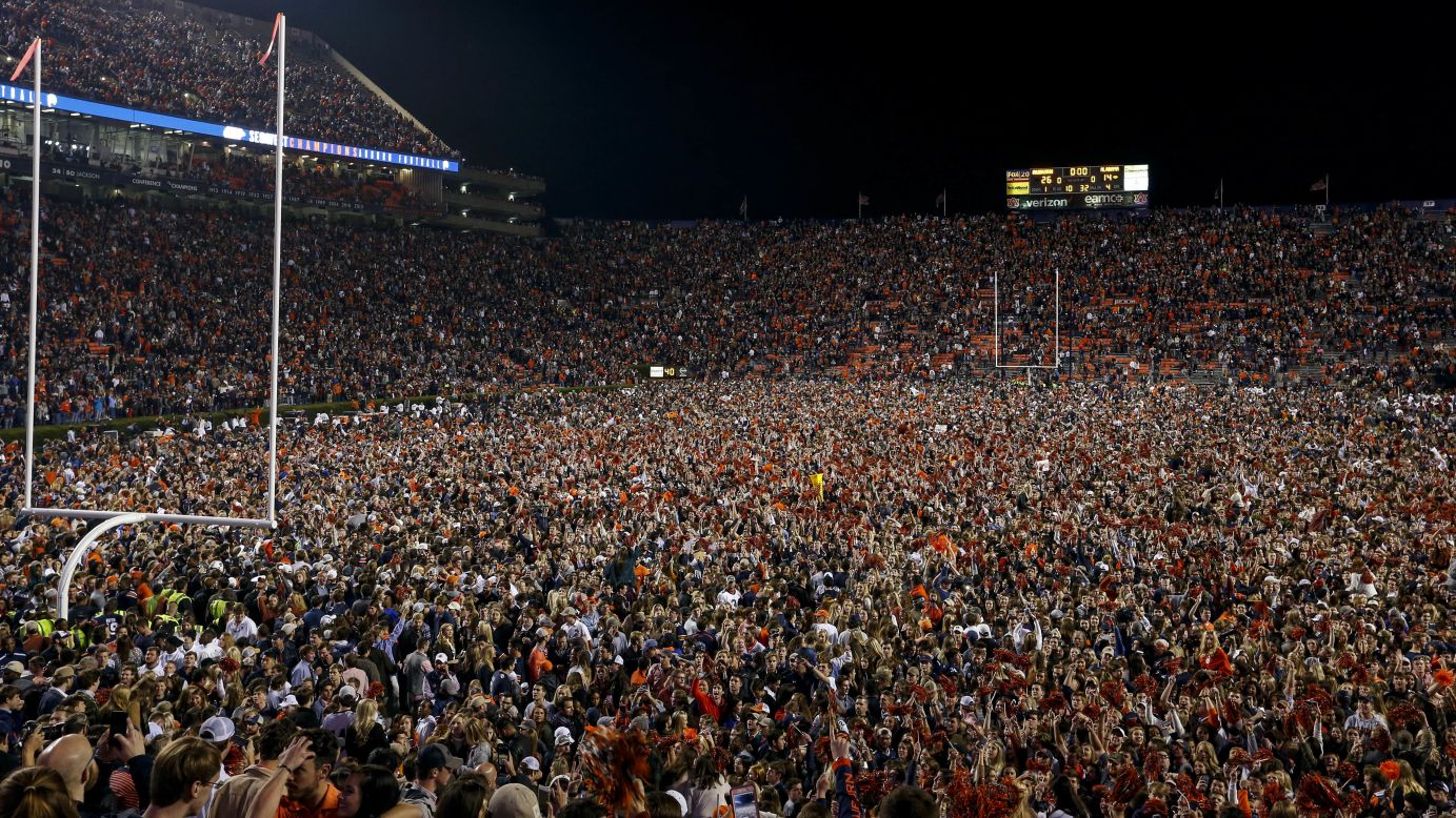 Auburn fans storm the field to celebrate the win over Alabama. The in-state rivalry, better known as the Iron Bowl, is one of college football's most intense matchups.