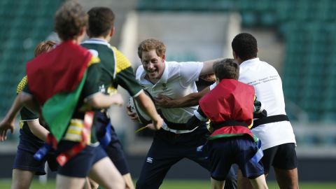 Harry plays rugby with children as he takes part in a coaching session in London in 2013.