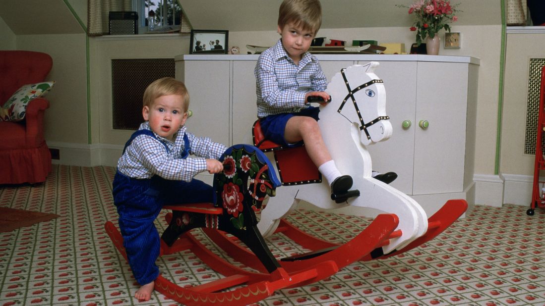 Harry, left, and William play on rocking horses at Kensington Palace.