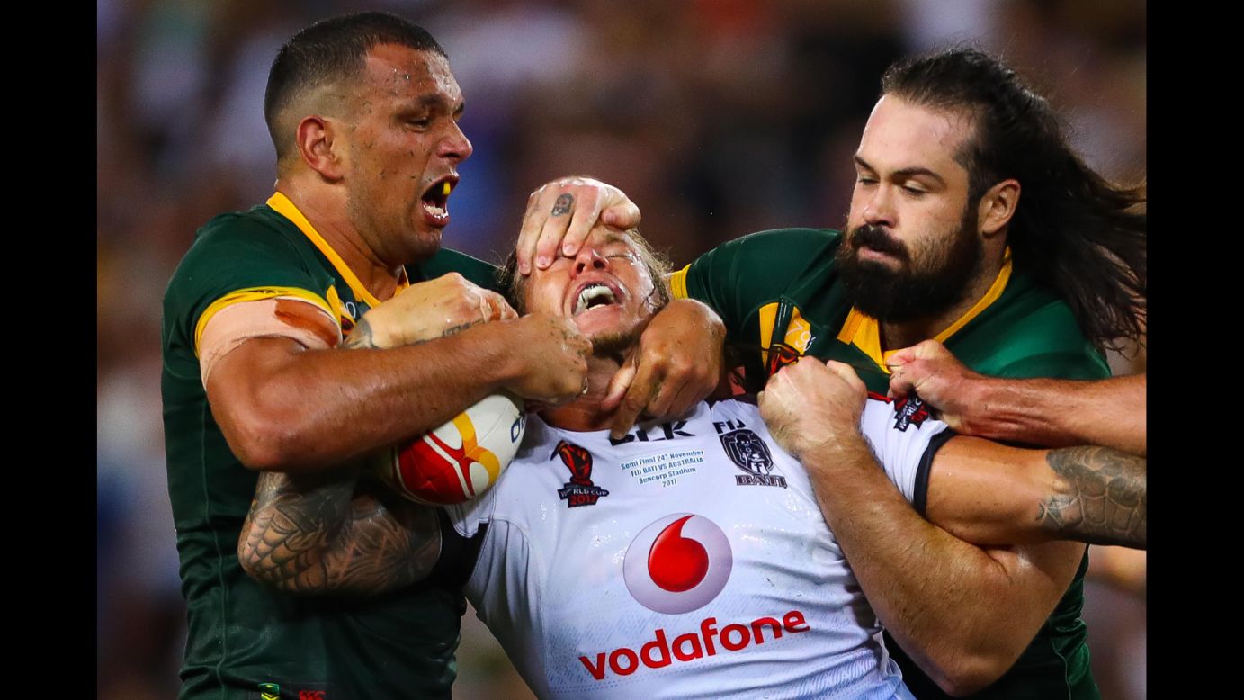 Fiji's Ashton Sims is tackled by Australia's Will Chambers, left, and Aaron Woods during the semifinals of the Rugby League World Cup on Friday, November 24. Australia won 54-6 to advance to the final against England.