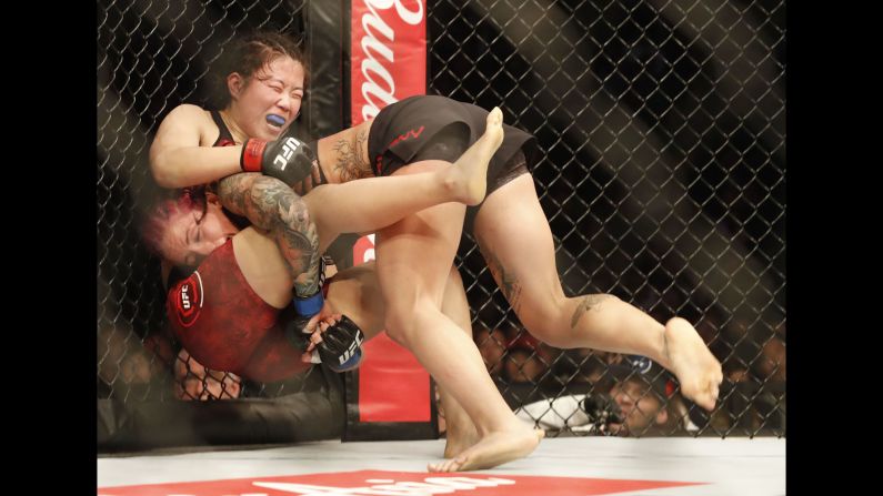 Gina Mazany takes down Wu Yanan during a UFC fight in Shanghai, China, on Saturday, November 25. Mazany won by unanimous decision.