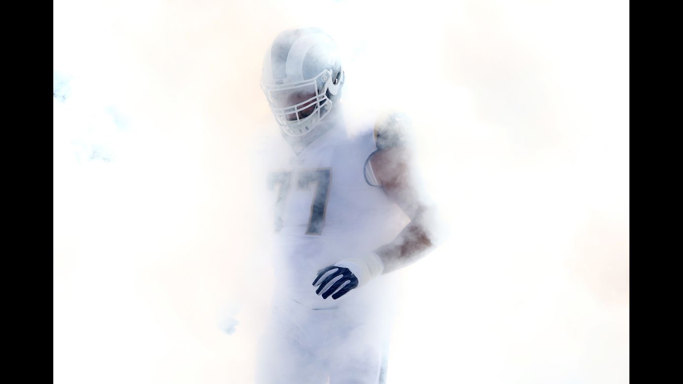 Smoke envelops Los Angeles Rams tackle Andrew Whitworth before an NFL game against New Orleans on Sunday, November 26.