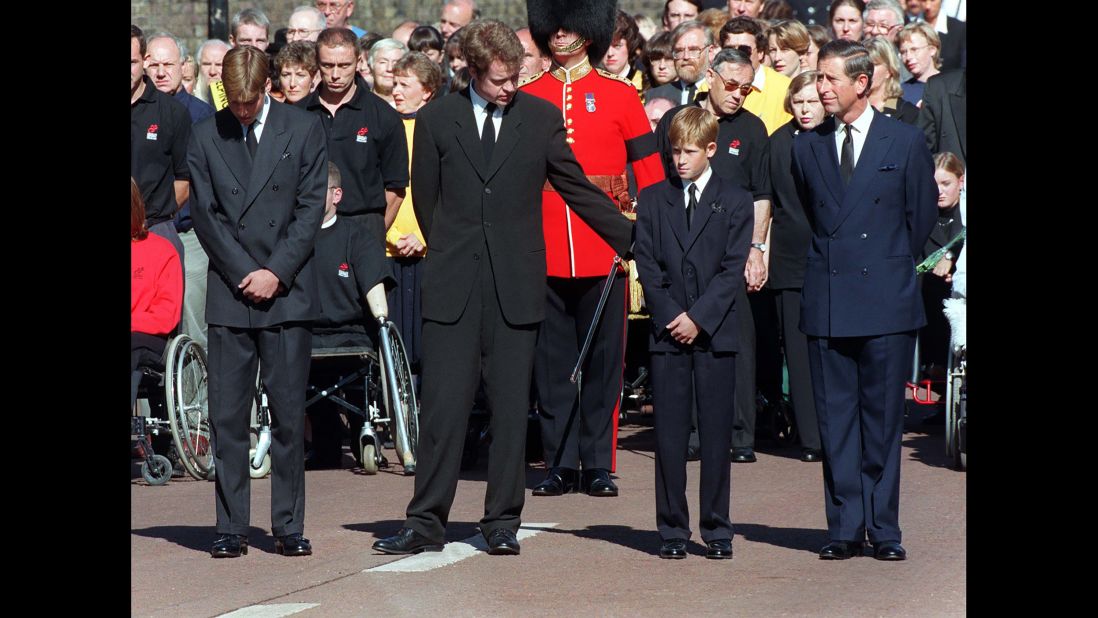 Princess Diana's brother, Earl Spencer, offers Harry a reassuring arm during her funeral service in 1997.