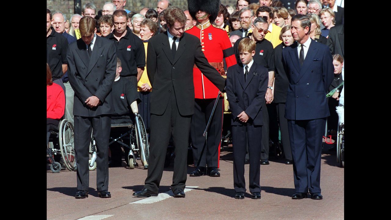 Princess Diana's brother, Earl Spencer, offers Harry a reassuring arm during her funeral service in 1997.