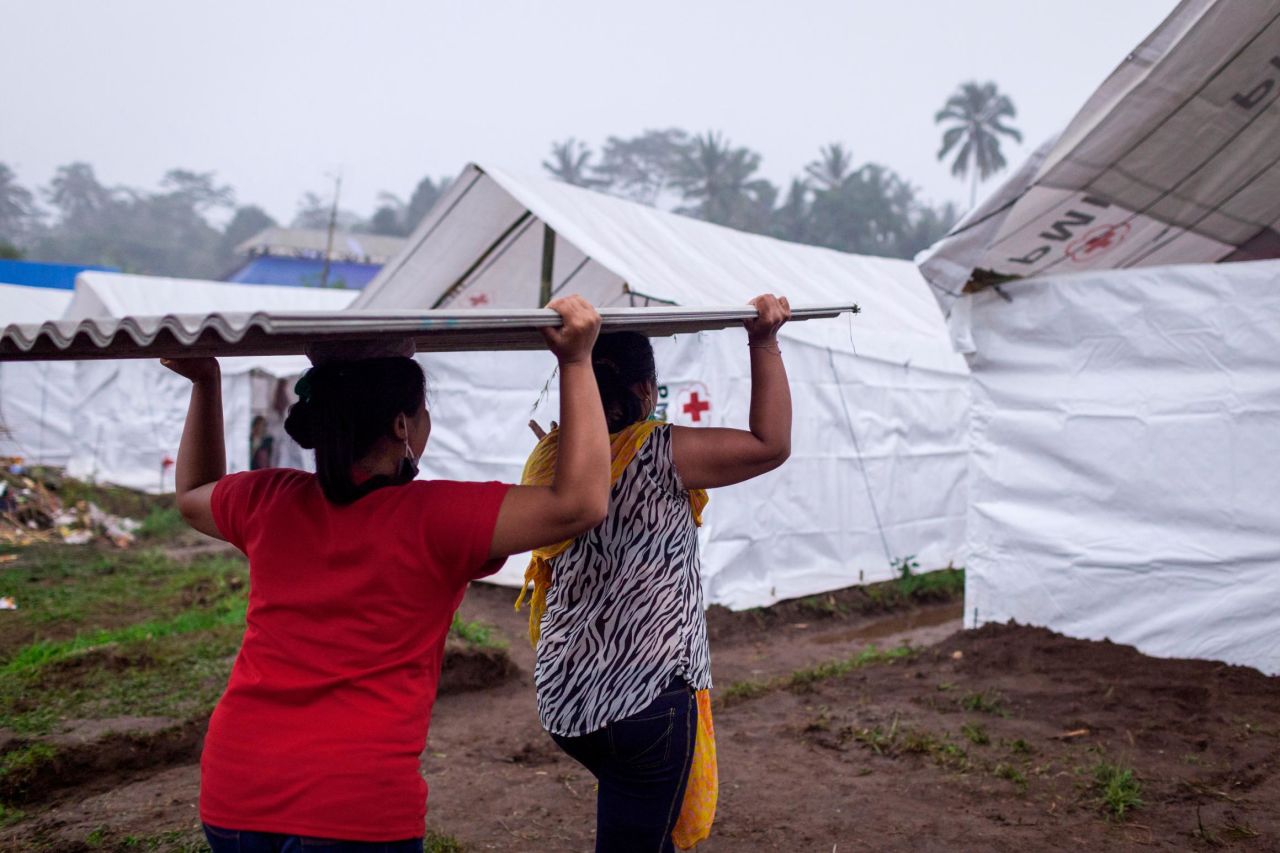Evacuees unload building materials for temporary shelters at Rendang Evacuation Center on November 27, in Karangasem, Bali, Indonesia.