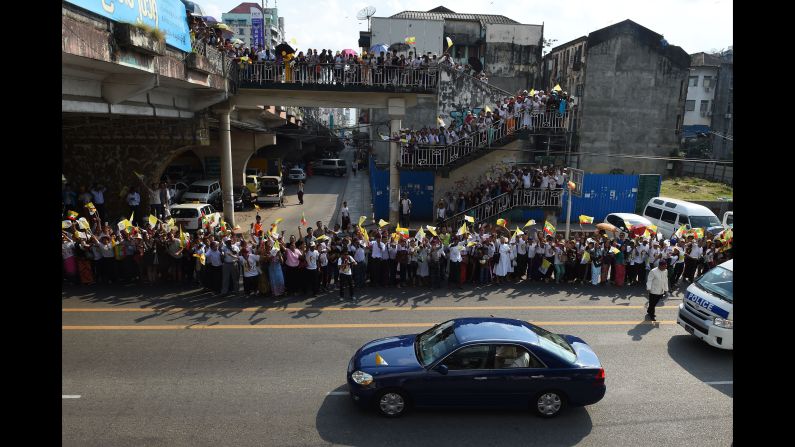 Crowds welcome Pope Francis' motorcade as it passes through Yangon on Monday, November 27. 