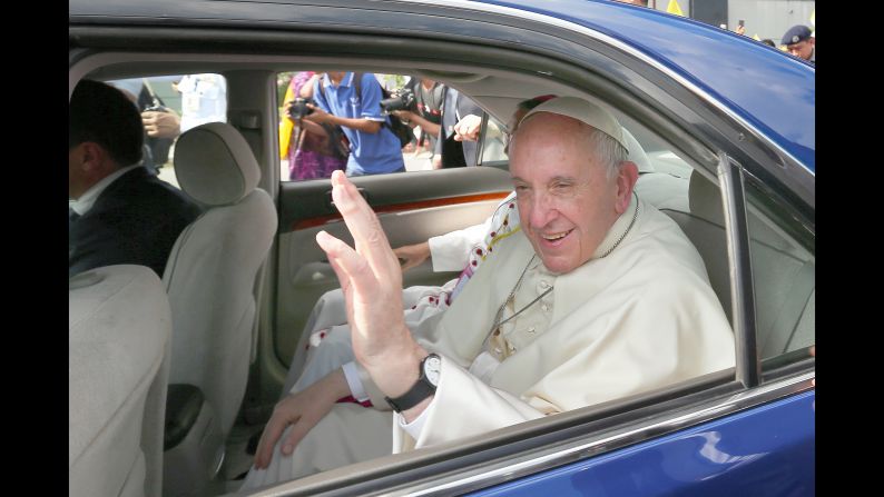 Pope Francis waves to admirers upon arrival at Yangon International Airport.