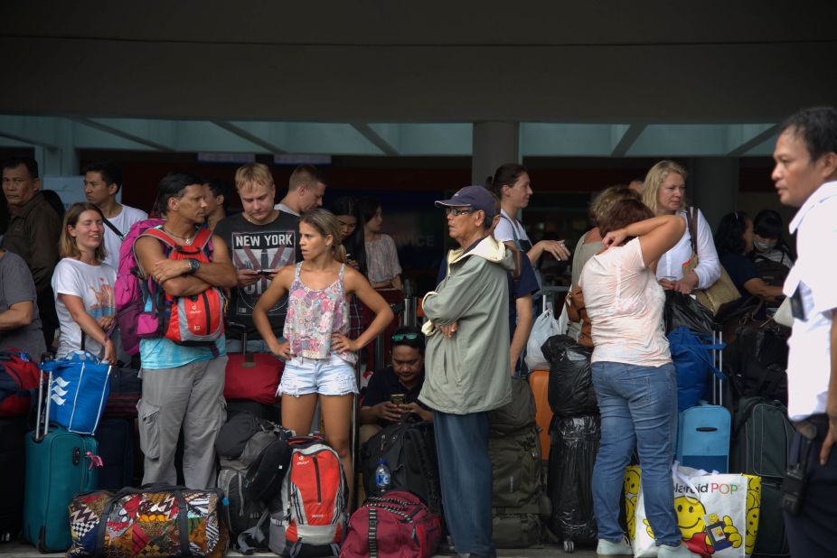 Passengers gather at the Ngurah Rai International Airport in Denpasar, Bali, on November 28, 2017, to wait for possible flights out after the Mount Agung volcano eruption.