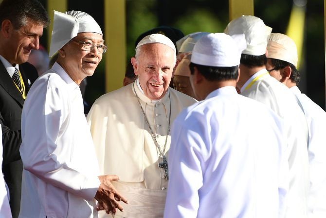 Pope Francis greets people with Myanmar President Htin Kyaw, second to left, during a welcoming ceremony on November 28, at the presidential palace in Naypyidaw.
