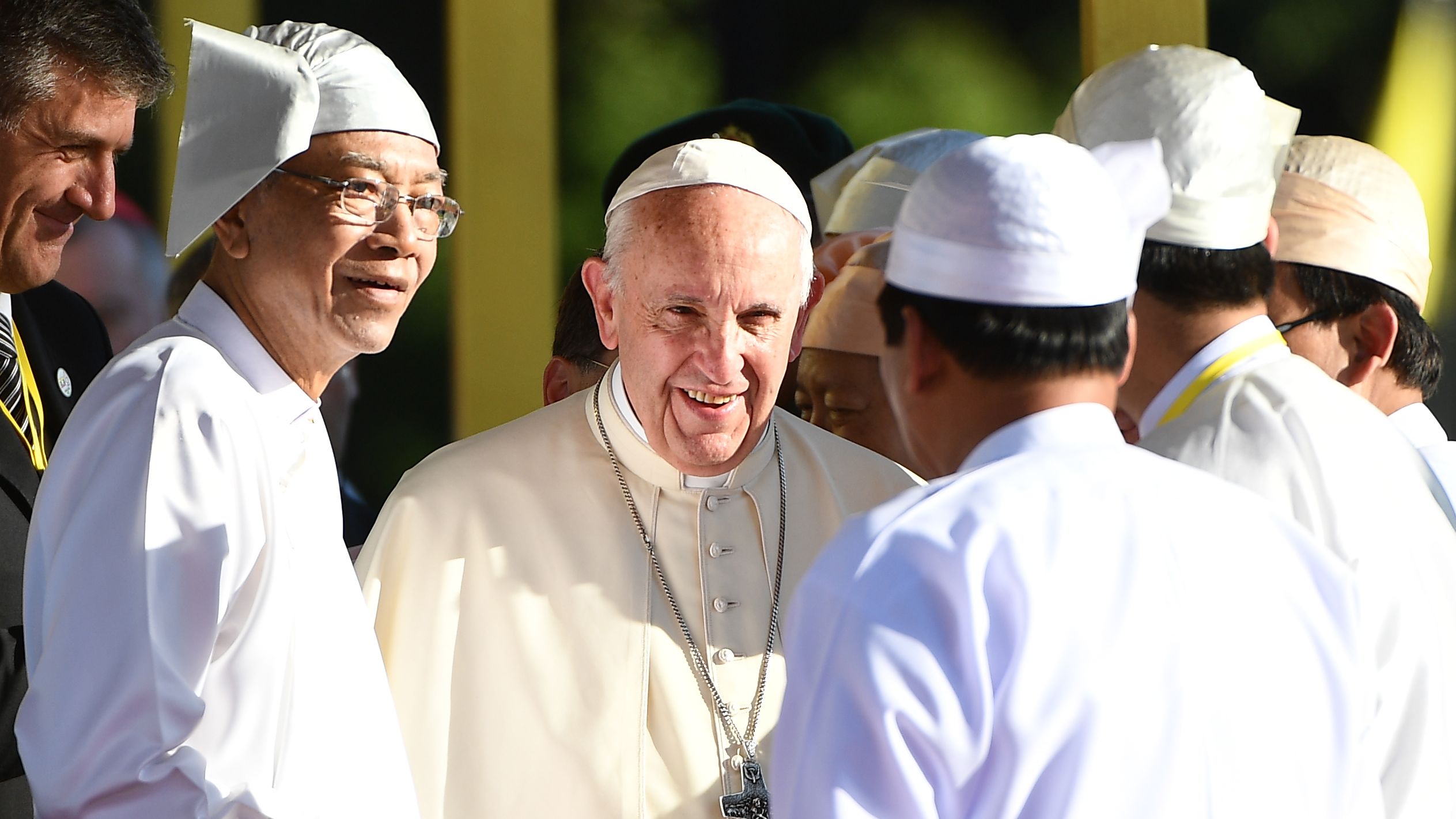Pope Francis (center) smiles beside Myanmar's President Htin Kyaw (second left) during a welcoming ceremony.