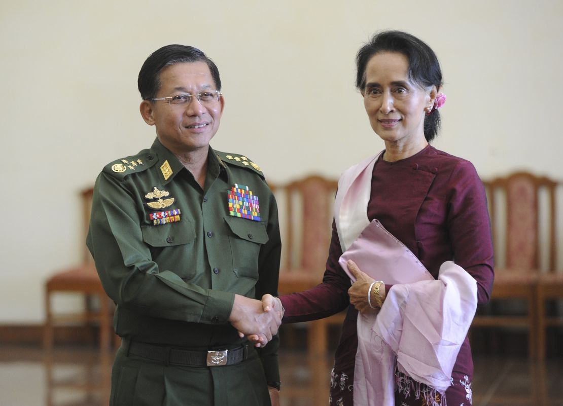 Senior General Min Aung Hlaing, Myanmar Commander In-Chief (L) and National League for Democracy (NLD) party leader Aung San Suu Kyi (R) shake hands after a meeting in Naypyidaw on December 2, 2015. 