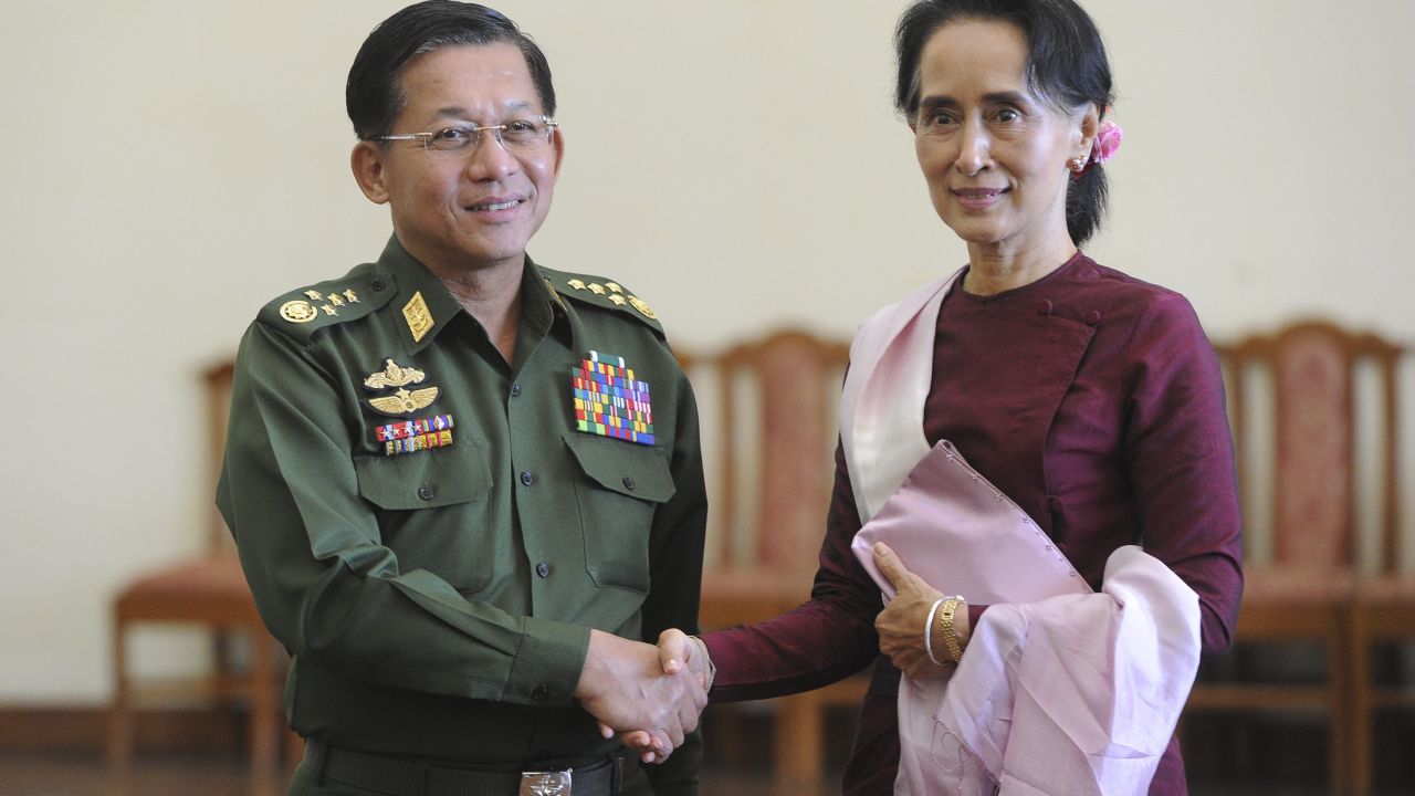 Senior General Min Aung Hlaing and Myanmar's de facto leader Aung San Suu Kyi shake hands at the Commander in-Chief's office in Naypyidaw on December 2, 2015.