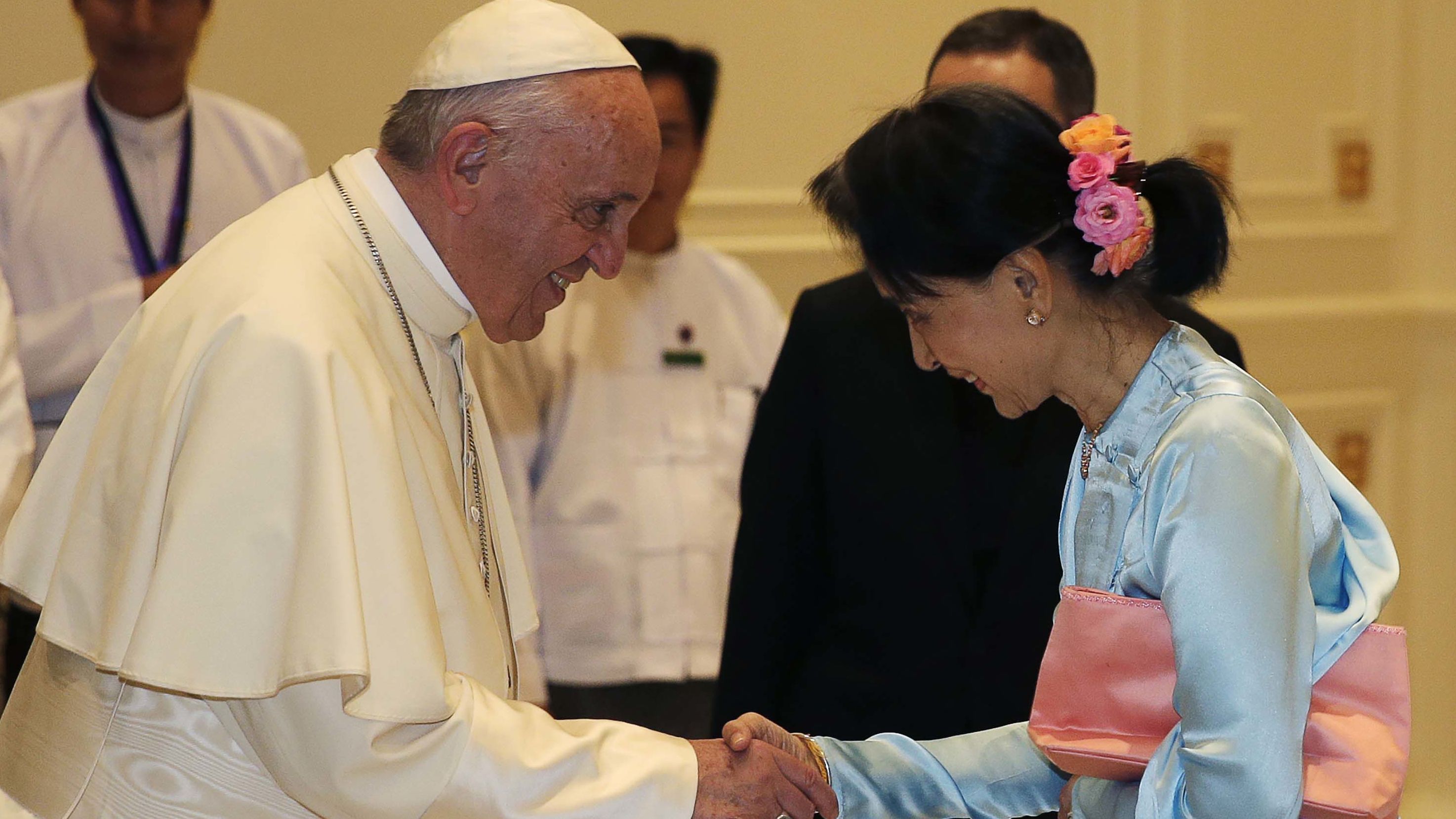Pope Francis (left) shakes hands with Aung San Suu Kyi on Tuesday. 