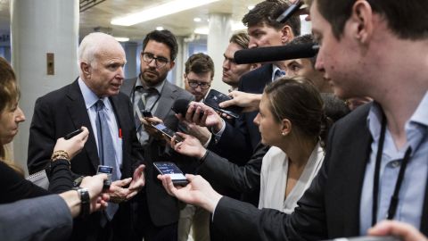 McCain speaks to members of the media while heading to a roll-call vote in October 2017.
