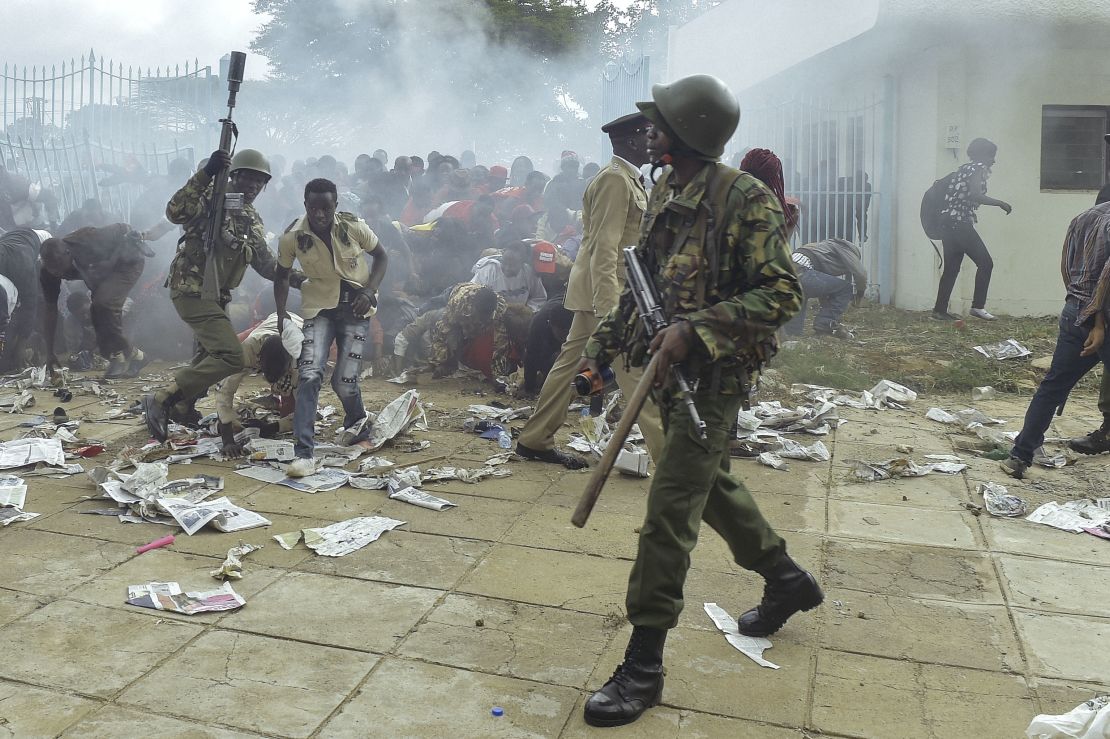 Police intervene during a stampede in Nairobi as supporters of Kenya's President try to get into his inauguration on November 28.