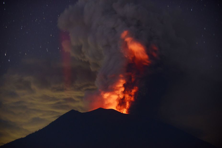 Smoke and ash is lit from within Mount Agung on November 28.