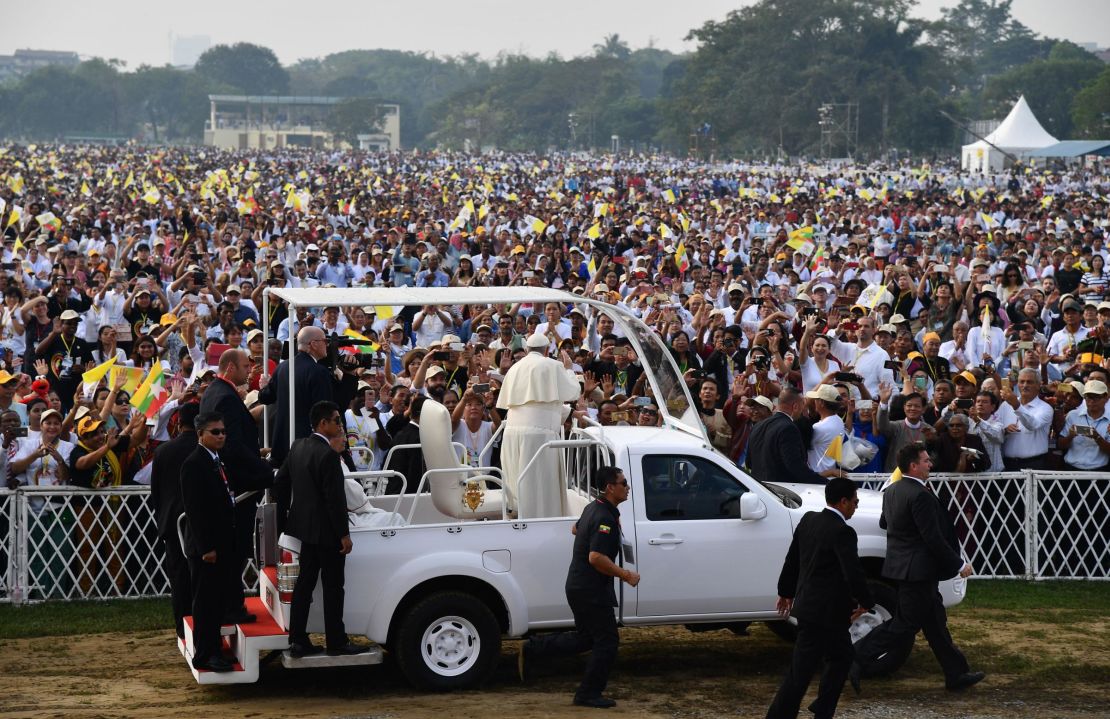 Pope Francis waves to Myanmar Catholic well wishers prior to an open air mass in Yangon on November 29, 2017.