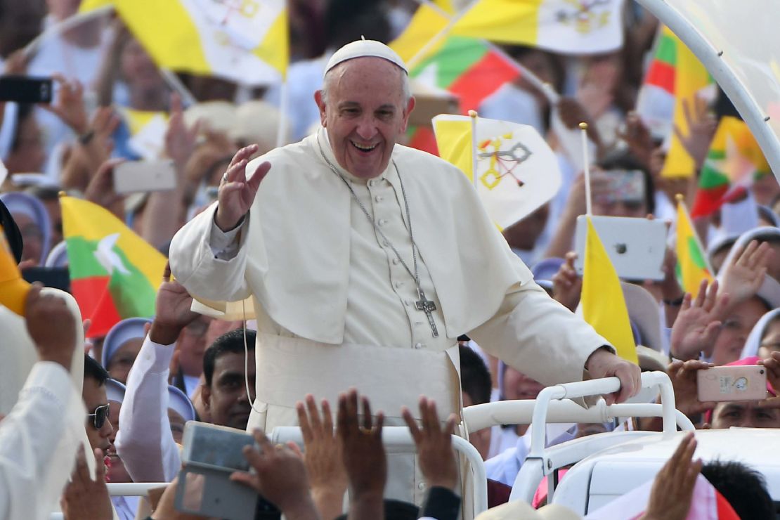 Pope Francis waves to the Catholic faithful as he arrives at the stadium where he is scheduled to say mass in Yangon on November 29, 2017.