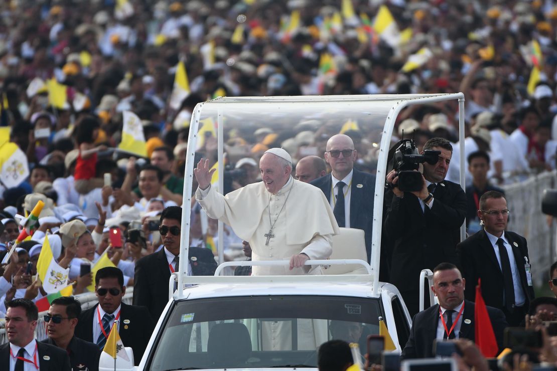 Pope Francis waves to Myanmar catholic well wishers as he arrives for an open air mass in Yangon on November 29, 2017.