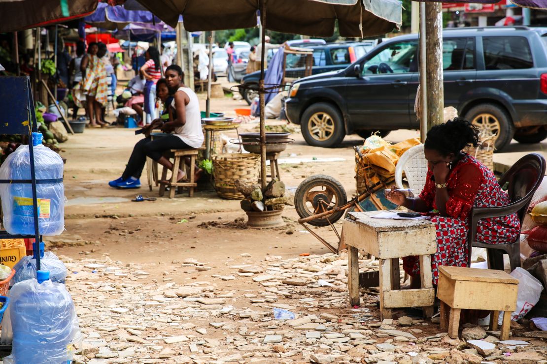 Traders peddle their ware at a market in Benin City, Nigeria, which for decades has been tied to trafficking to Europe.