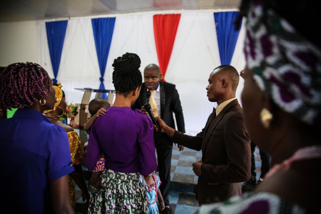 Pastor Etinosa Osiomwanhi interacts with his congregation during a Sunday service. He denies that Sandra's trafficker was an assistant pastor at his church. "You know pastors do certain things," he said. "I don't call them pastors, I call them herbalists or native doctors in suits who would do such."