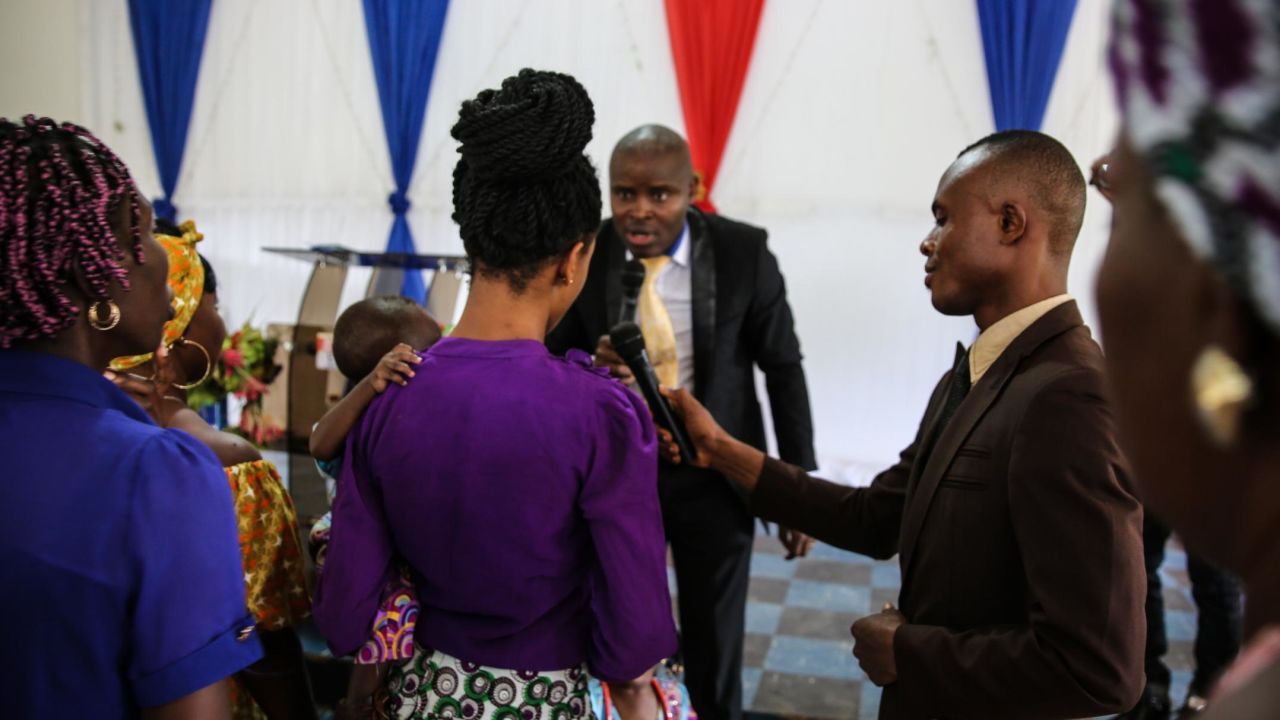 Pastor Etinosa Osiomwanhi interacts with his congregation during a Sunday service. He denies that Sandra's trafficker was an assistant pastor at his church. "You know pastors do certain things," he said. "I don't call them pastors, I call them herbalists or native doctors in suits who would do such."
