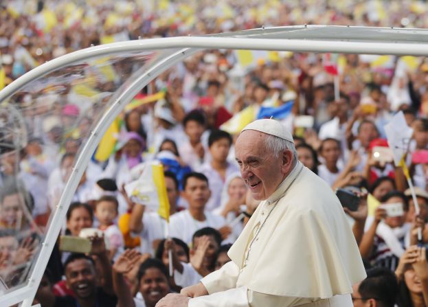 Pope Francis greets worshippers who had gathered for an open-air Mass at a football stadium in Yangon, Myanmar, on Wednesday, November 29.