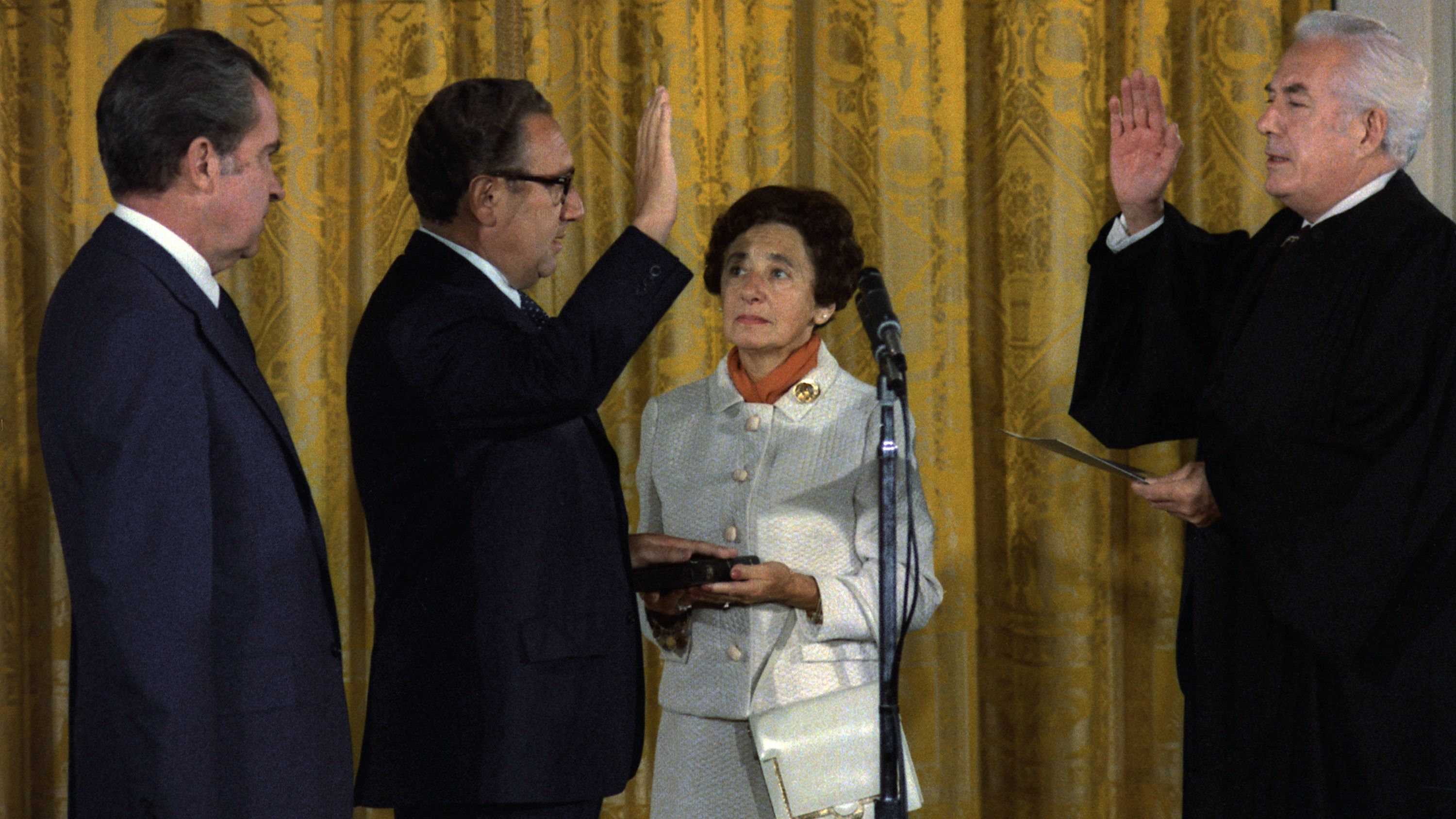 With Nixon watching, Kissinger is sworn in as Secretary of State by Chief Justice Warren Burger in 1973. Nixon called it "very significant in these days when we must think of America as part of the whole world community that for the first time in history a naturalized citizen is the secretary of state of the United States."