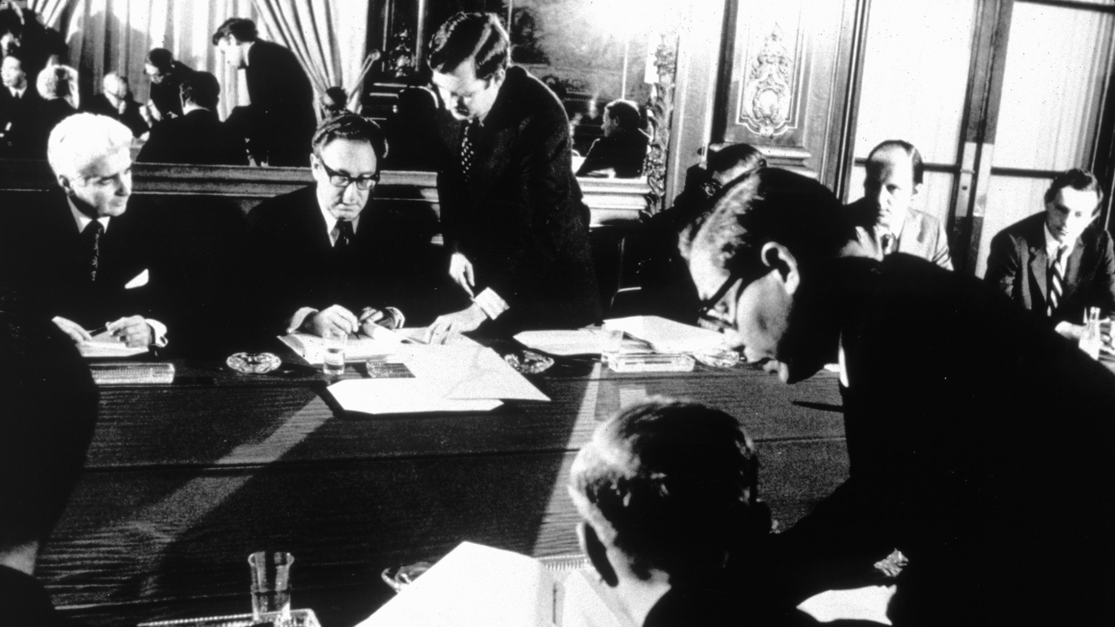 Kissinger and Vietnamese politician Le Duc Tho sign the Paris Peace Accords in 1973. The two men later were awarded the Nobel Peace Prize, but Tho refused to accept it.