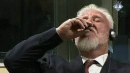Slobodan Praljak drinks the contents of a small vial in a Hague courtroom on Wednesday, November 29, 2017.