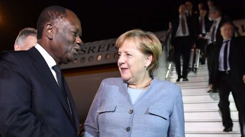 Ivorian president Alassane Ouattara welcomes German Chancellor Angela Merkel as she arrives in Abidjan for the summit.