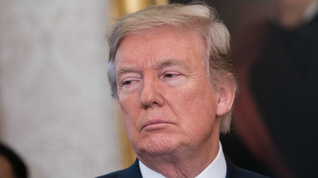 US President Donald Trump listens to a speaker as he announces that Broadcom would be moving back to the US in the Oval Office at the White House in Washington, DC, on November 2, 2017.