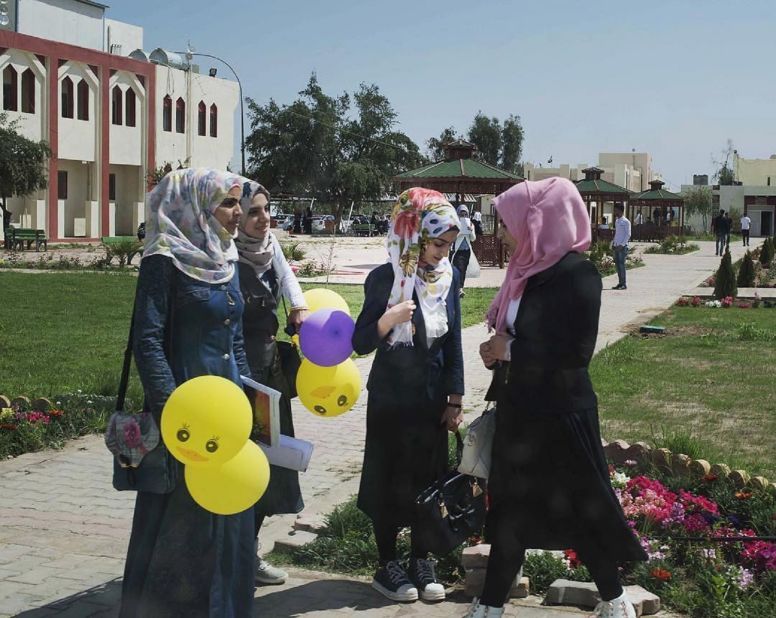 Mackenzie took this photograph at Tikrit University in Iraq, which was largely destroyed in the fight to liberate the city from ISIS in 2015. Now, on a warm spring day, it feels like any other university, with that end of the year excitement in the air, she says.