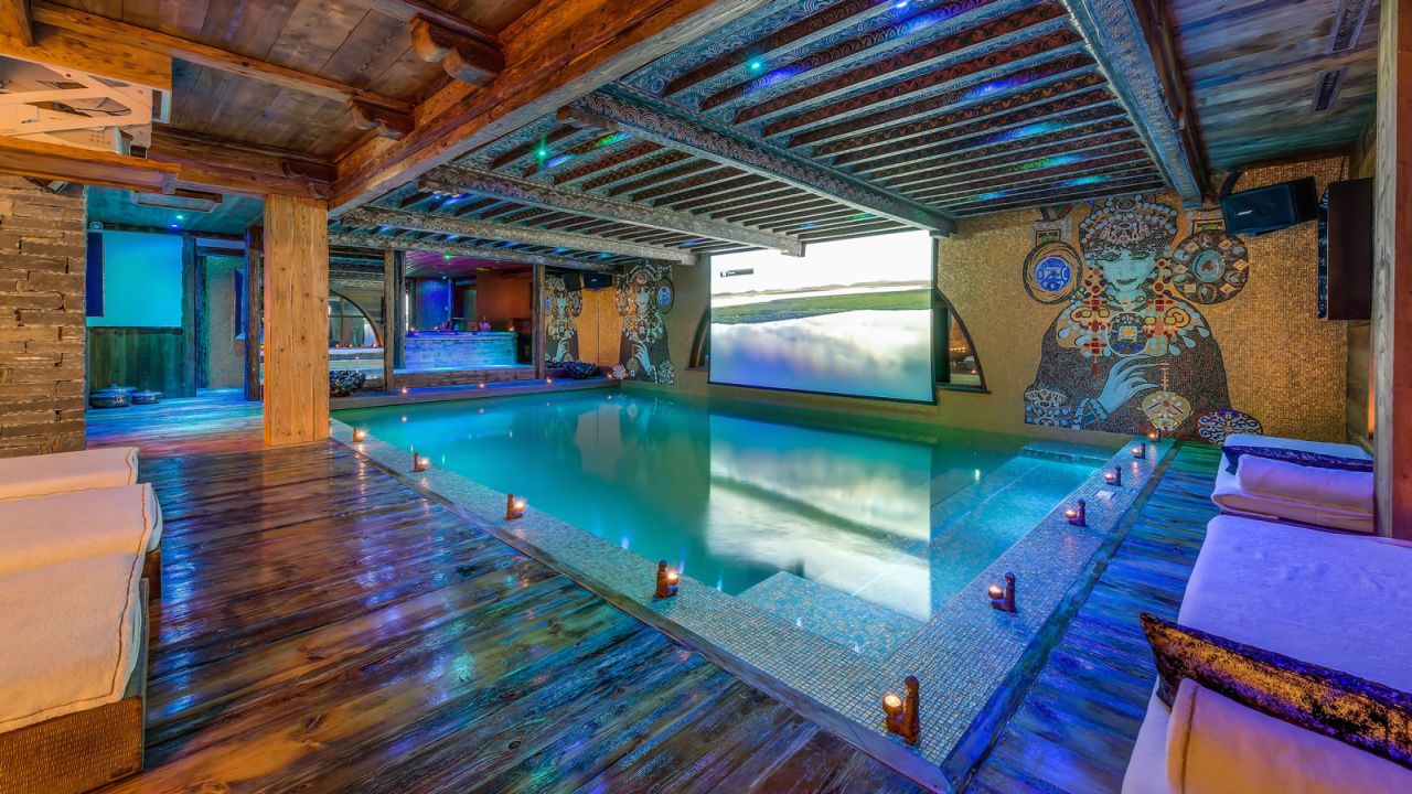 The gold leaf swimming pool at Chalet Marco Polo has its own cinema screen.