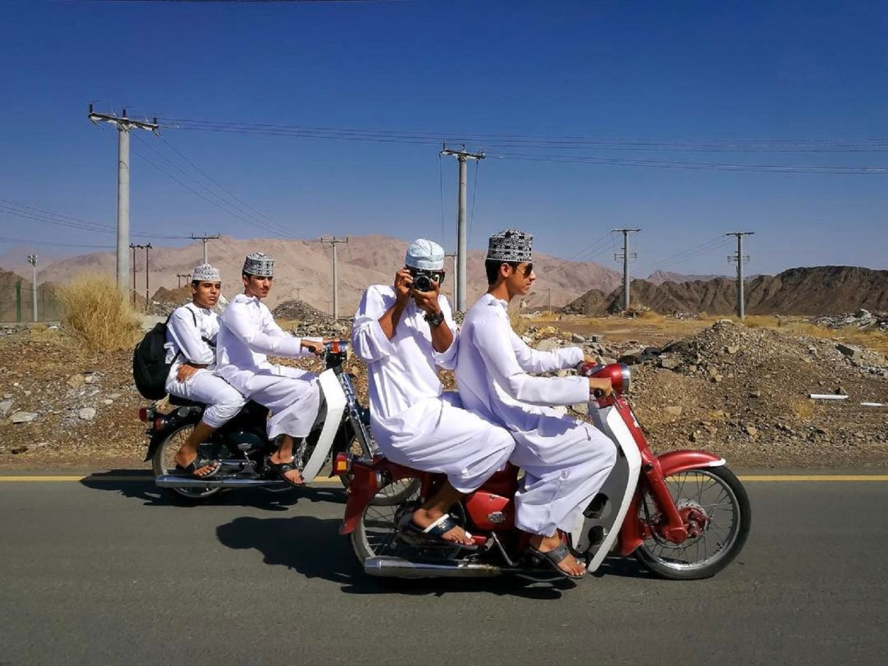 Young men travel on their motorbikes in Nizwa, Oman