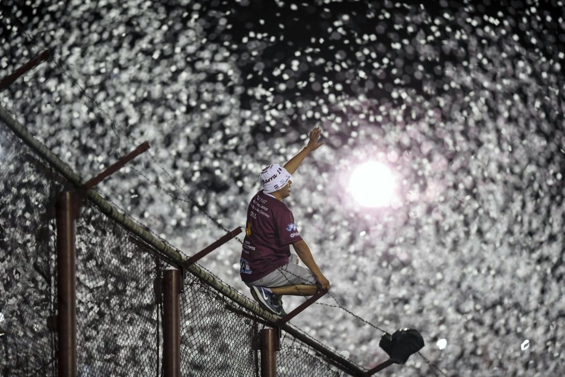 A Lanus fan cheers his team on before kick off.