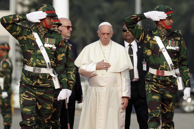Pope Francis passes members of the honor guard as he arrives at Dhaka's international airport in Bangladesh on November 30.