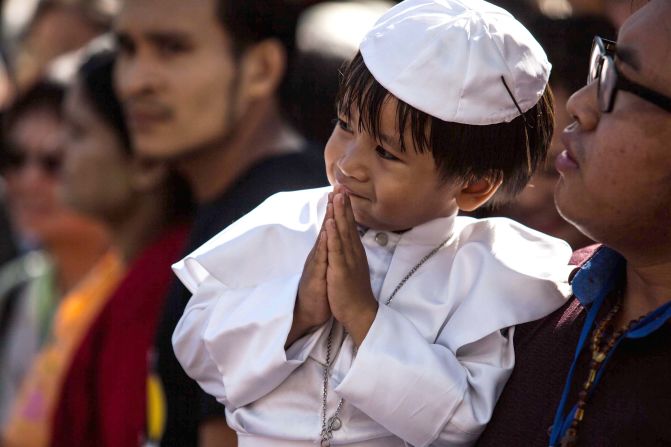 A young boy in a miniature Pope outfit is seen waiting outside St. Mary's Catholic Church in Yangon, awaiting Pope Francis' arrival November 30.