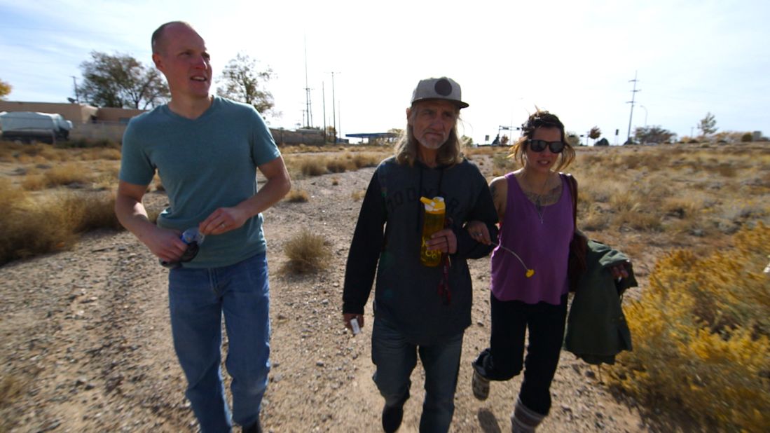 Holets walks with Hope's birth parents, Tom Key and Crystal Champ.