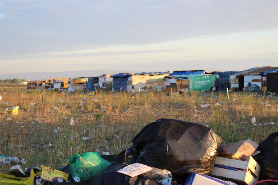 Trash litters the fields around the Runway Ghetto.